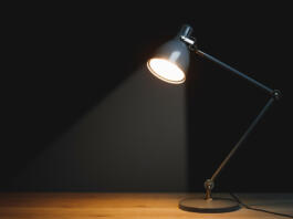 desk lamp with spotlight, black background with copy-space