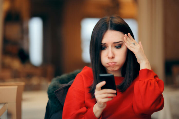 Forgetful woman receiving online notifications on her phone