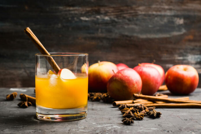 Old fashioned apple beverage on the rustic background. Selective focus.