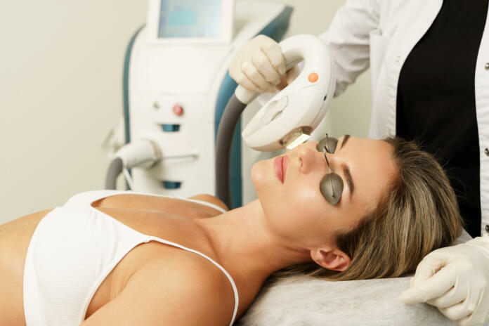 Woman client during IPL treatment in a cosmetology medical clinic