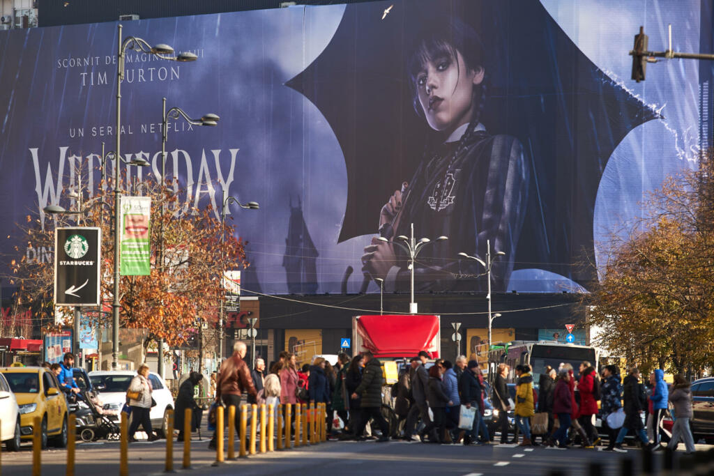 Bucharest, Romania - November 22, 2022: Extra large banner advertising Wednesday TV Series is displayed on the Unirea Shopping Center, in downtown Bucharest. This image is for editorial use only.