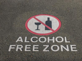 closeup of alcohol free zone sign on pavement