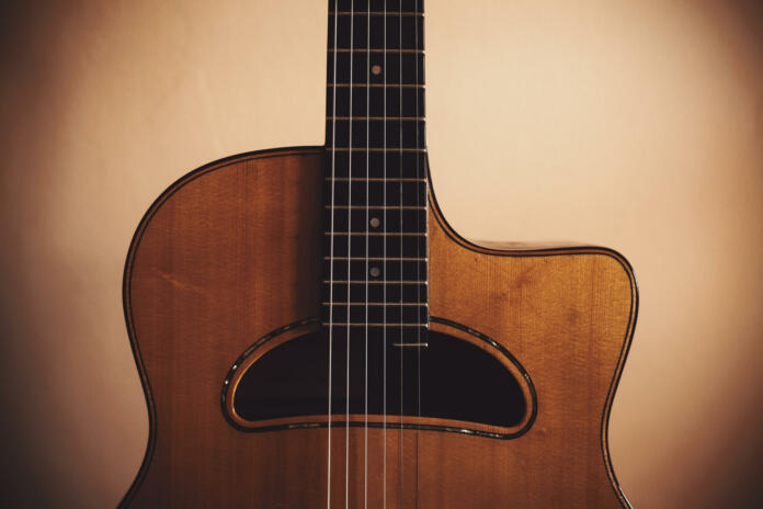 Closeup view of an old manouche acoustic guitar, vintage style.