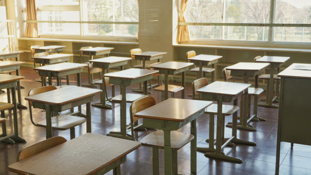 Desks and chairs in an empty classroom. This is Japanese school.