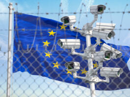 Flag of Europen Union EU behind barbed wire fence and cctv cameras. Concept of closing borders from refugees, discrimination and violation of human rights and freedom in EU. 3d illustration