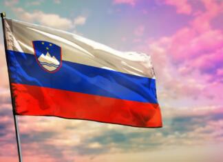 Literarni natečaj 2023: Objavljen razpis za promocijo slovenskega jezika Fluttering Slovenia flag on colorful cloudy sky background. Slovenia prospering concept.