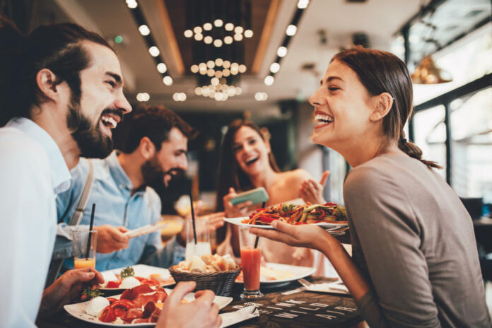 Group of Happy friends having breakfast in the restaurant