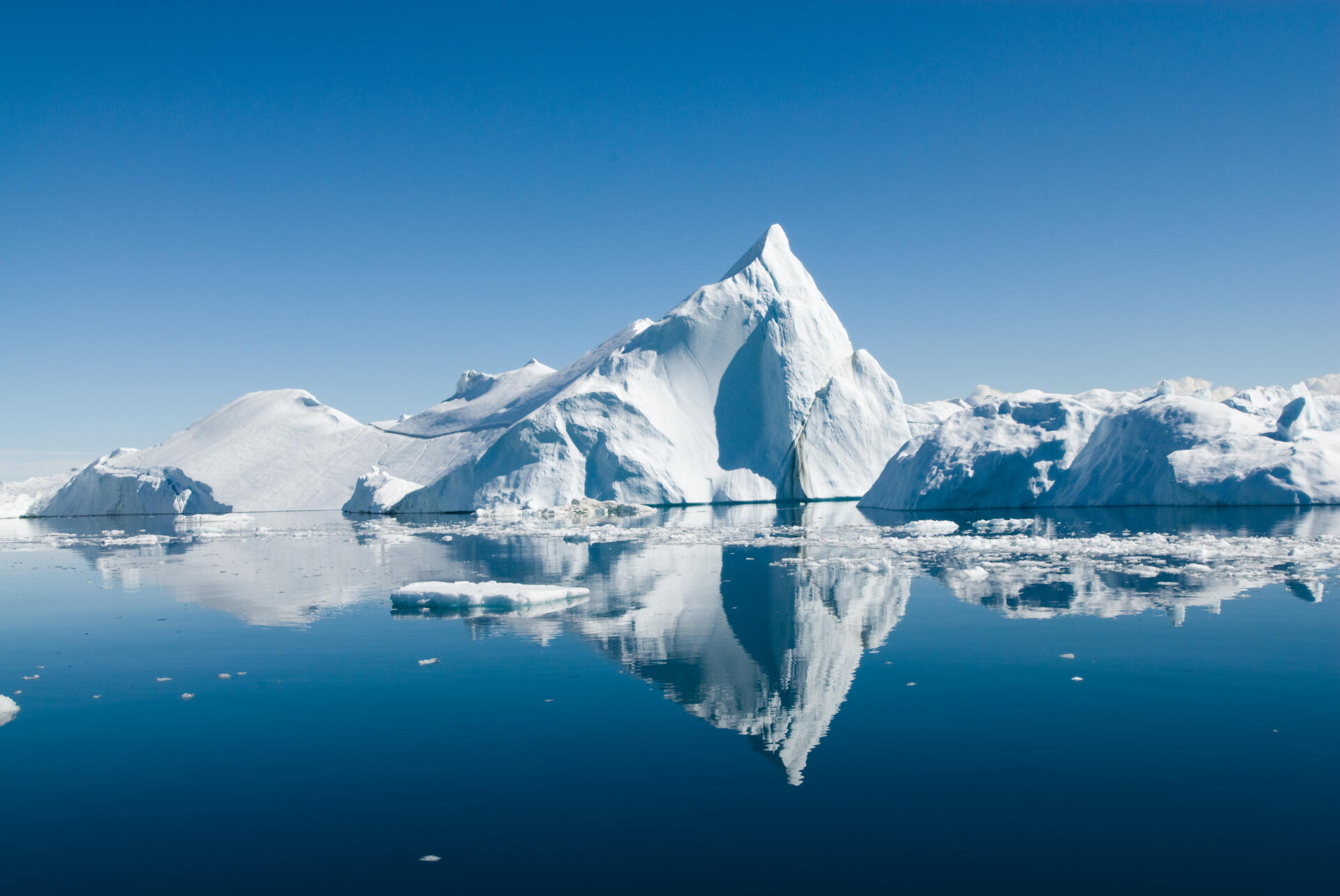 Icebergs drift in calm seas off the Greenland coast.