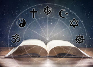 Koliko religij je na svetu? Vere po svetu danes Open book on wooden table with religious symbols and universe background. Concept of the study of religions. Front view.