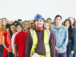 Portrait of confident construction worker and crowd