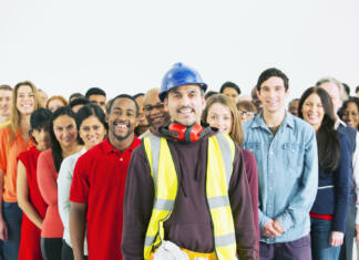 Najbolj iskani poklici v letu 2023 Portrait of confident construction worker and crowd