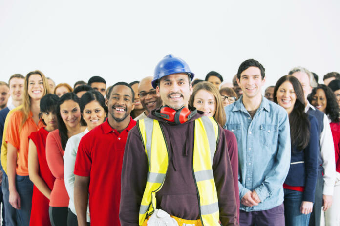 Portrait of confident construction worker and crowd