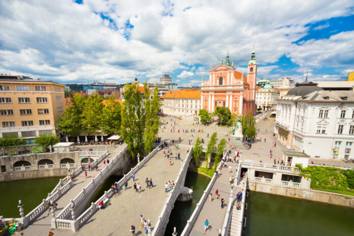 Romantic Ljubljana city center: river Ljubljanica, Triple Bridge (Tromostovje), Preseren square and Franciscan Church of the Annunciation; Ljubljana, Slovenia, Europe.