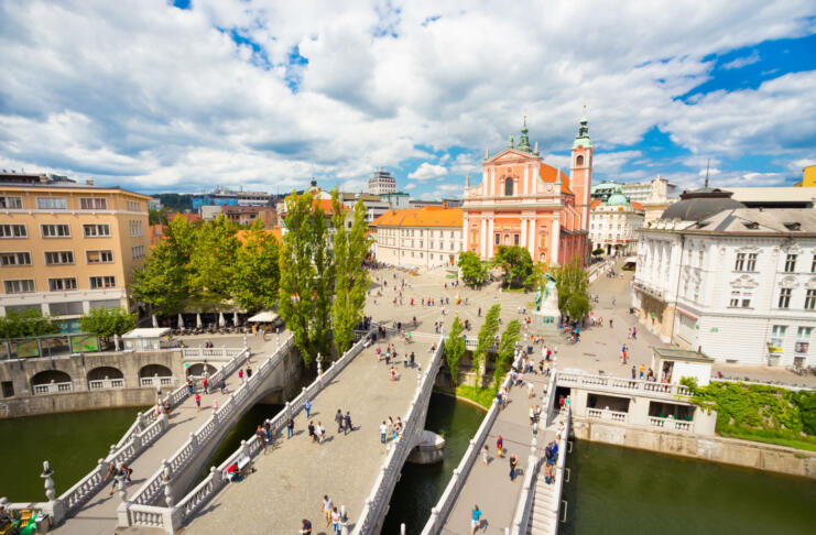 Romantic Ljubljana city center: river Ljubljanica, Triple Bridge (Tromostovje), Preseren square and Franciscan Church of the Annunciation; Ljubljana, Slovenia, Europe.