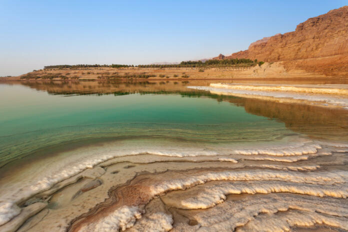 Salty beach on the shore of the Dead Sea in Jordan