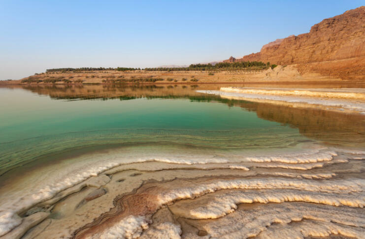 Salty beach on the shore of the Dead Sea in Jordan