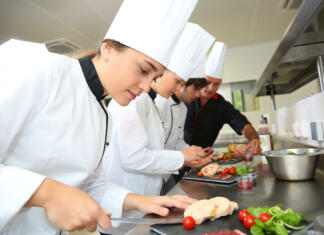 Štipendije deficitarnih poklicev v gostinstvu in turizmu Team of young chefs preparing delicatessen dishes