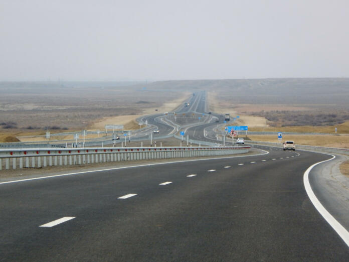 Traffic on the motorway. Cavity Karagiye. Mangistau region. Kazakhstan.