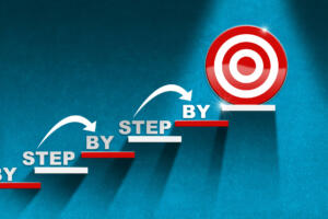 3D illustration of a stair with red and white steps on a blue wall with a target on the last step and text Step by Step. Ladder of success or Goal concept.