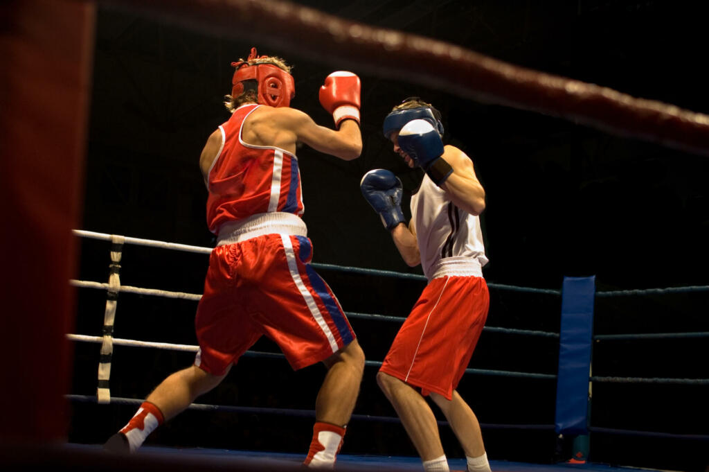 Agressive boxing fight, two boxers fighting on the ring.