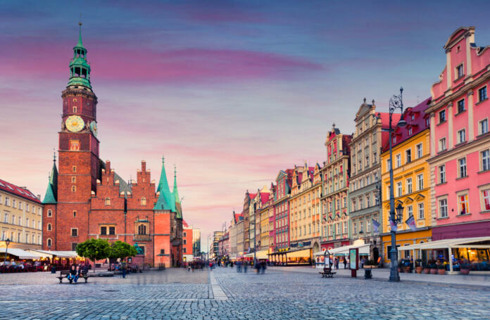 Colorful evening scene on Wroclaw Market Square with Town Hall. Sunset in historical capital of Silesia, Poland, Europe. Artistic style post processed photo.