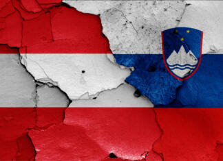 Komentar: Kampf na avstrijskem Koroškem flags of Austria and Slovenia painted on cracked wall