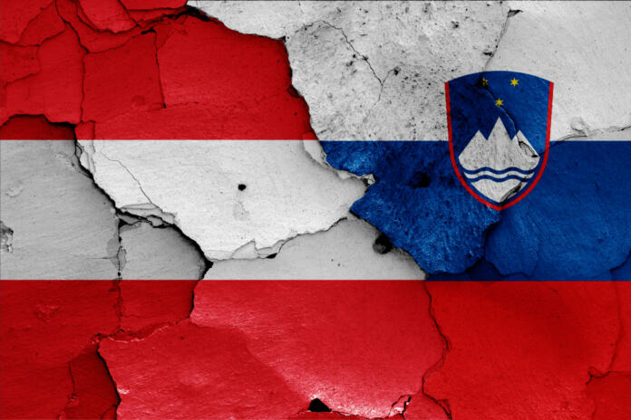 flags of Austria and Slovenia painted on cracked wall
