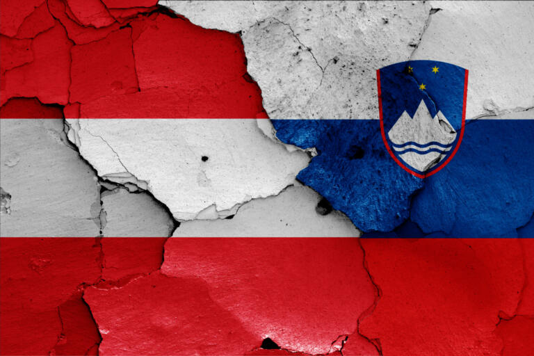 flags of Austria and Slovenia painted on cracked wall