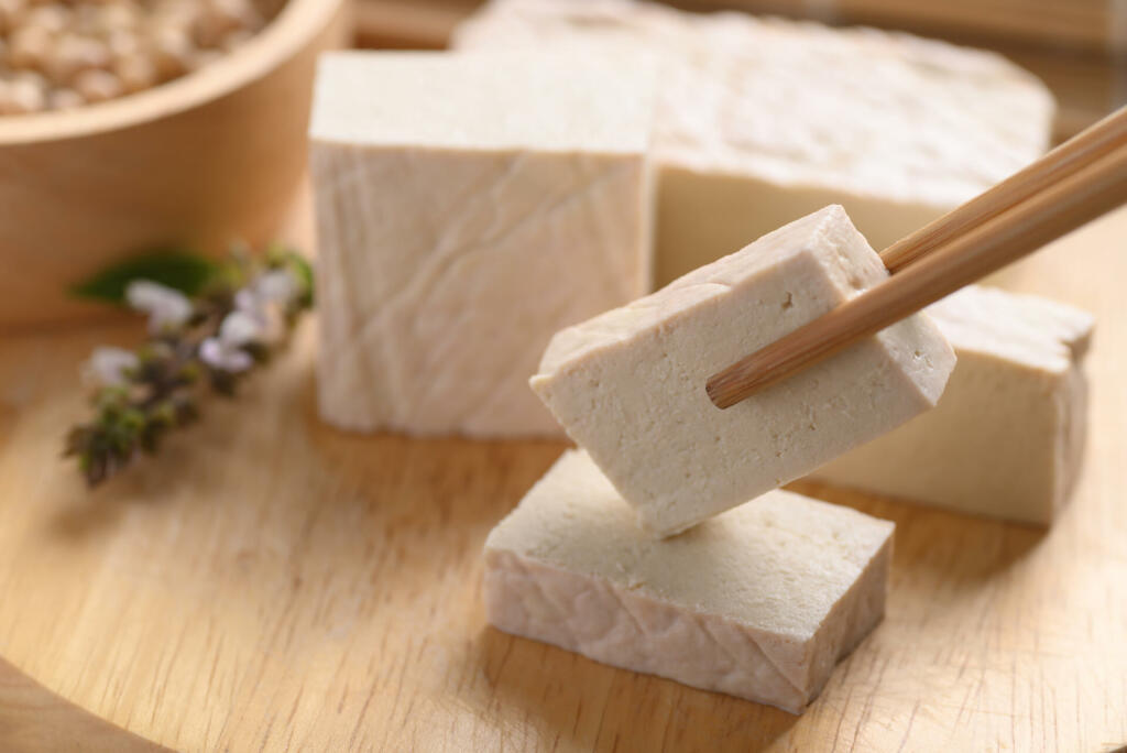 Fresh Tofu eating by chopsticks on wooden cutting board, Food ingredient in Asian cuisine