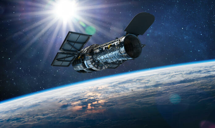 Hubble telescope on orbit of Earth. Space observatory. Telescope in outer space near surface of blue planet. Stars and sun. Elements of this image furnished by NASA (url:https://science.nasa.gov/science-red/s3fs-public/styles/large/public/thumbnails/image/Hubble-sm.png https://www.nasa.gov/sites/default/files/styles/full_width_feature/public/thumbnails/image/iss063e074377.jpg)