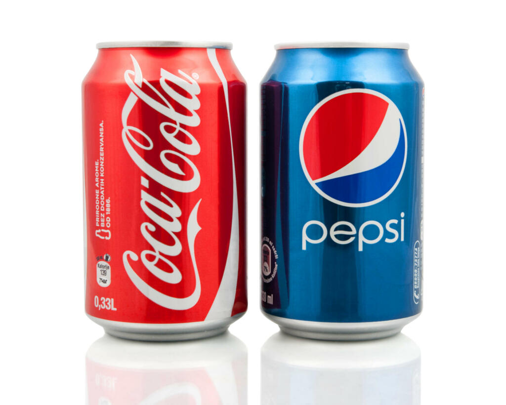 Kragujevac, Serbia - January 27, 2014: Coca-Cola and Pepsi cans on white background. Symbolic representation of one of the greatest business rivalries of all time.