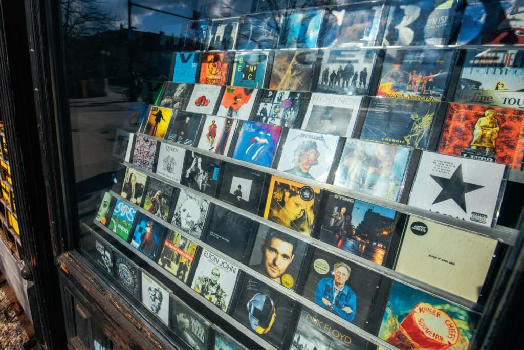 LJUBLJANA, SLOVENIA - FEBRUARY 19, 2017:  Shadow of unrecognizable person standing in front of the music, games and movies CD and DVD shop window in Ljubljana, capital of Slovenia