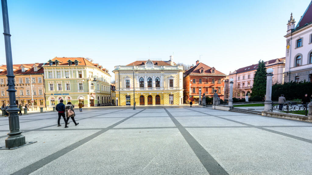 Ljubljana, Slovenia - January 23, 2018: The Slovenian Philharmonic Building on Congress square (Kongresni trg), University of Ljubljana and Ljubljana Castle in background.