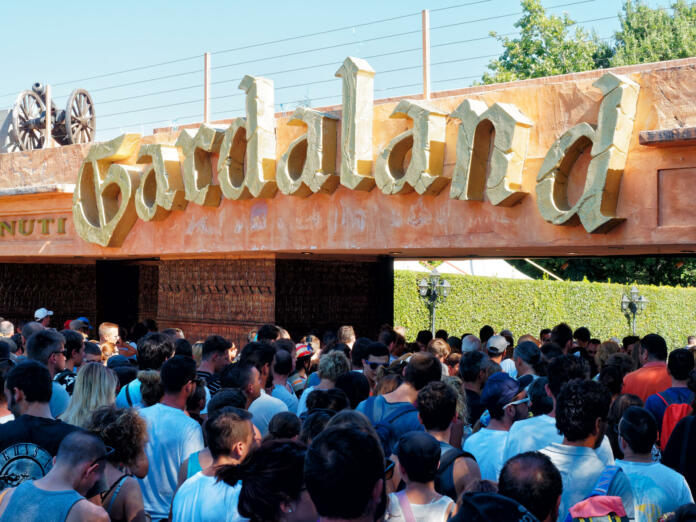 Peschiera del Garda, Italy - Aug 2016: People queue at entrance of funfair Gardland