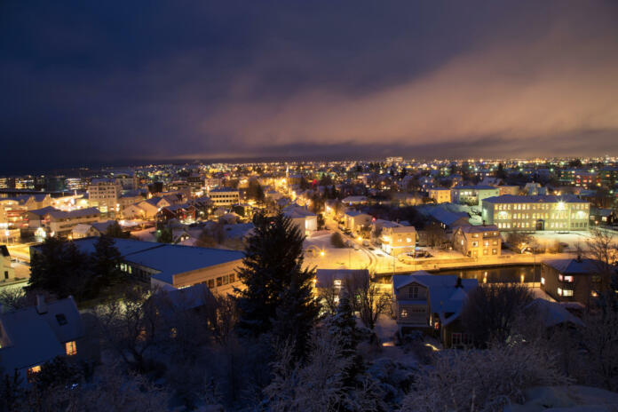 Shot over the Reykjavik area at christmas time, covered in snow with christmas lights and pine trees