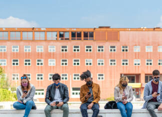 Zbornik Prostori za mlade: Izšel je, ko smo ga najbolj potrebovali! social and emotional distancing caused by the coronavirus pandemic, multiracial group of people isolated each on his smartphone, communication with the virtual world, the new normal way of life