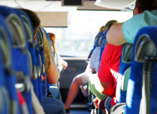 Ideje za zaključni izlet Transport, tourism, road trip and people concept. People in the intercity bus. Group of passengers or tourists in travel bus