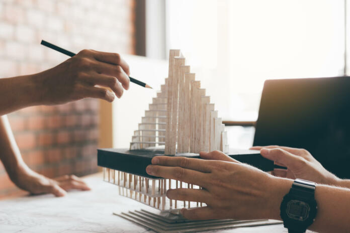 Architect reviewing architectural model in the office.