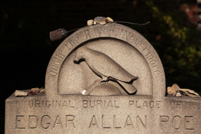 Before being moved in 1875, Edgar Allan Poe was buried in the back of Westminster Hall in Baltimore, MD. This stone marks the site of the original grave where the author was buried in 1849. Above the stone a black rose to honor the author.