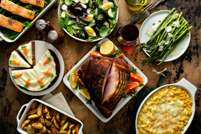 Easter dinner table with ham, asparagus and carrot cake