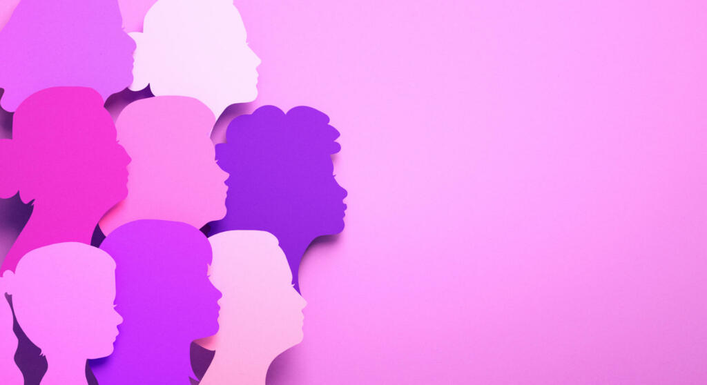 International Women's Day poster with silhouettes of multicultural women's faces in paper cut style and copy space. Sisterhood, female independence and equality in 3D illustration