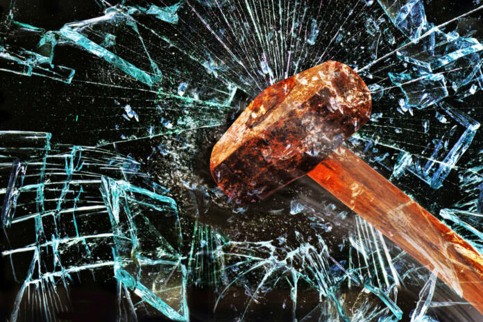 Iron hammer breaking glass window.