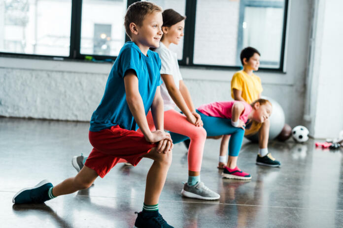 Kids warming up before training in gym