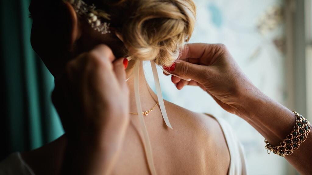 tying hair, woman, hands