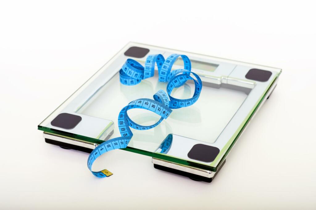 Blue tape measuring on clear glass square weighing scale