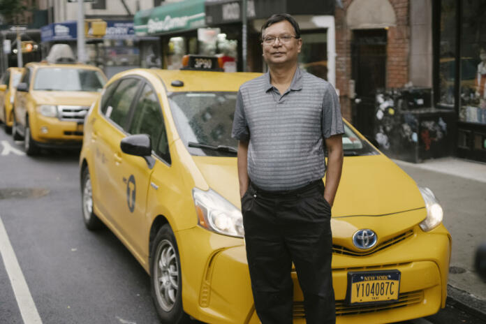 Calm man standing near taxi