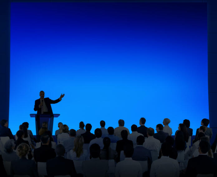 Group Of Business People Listening To A Speech