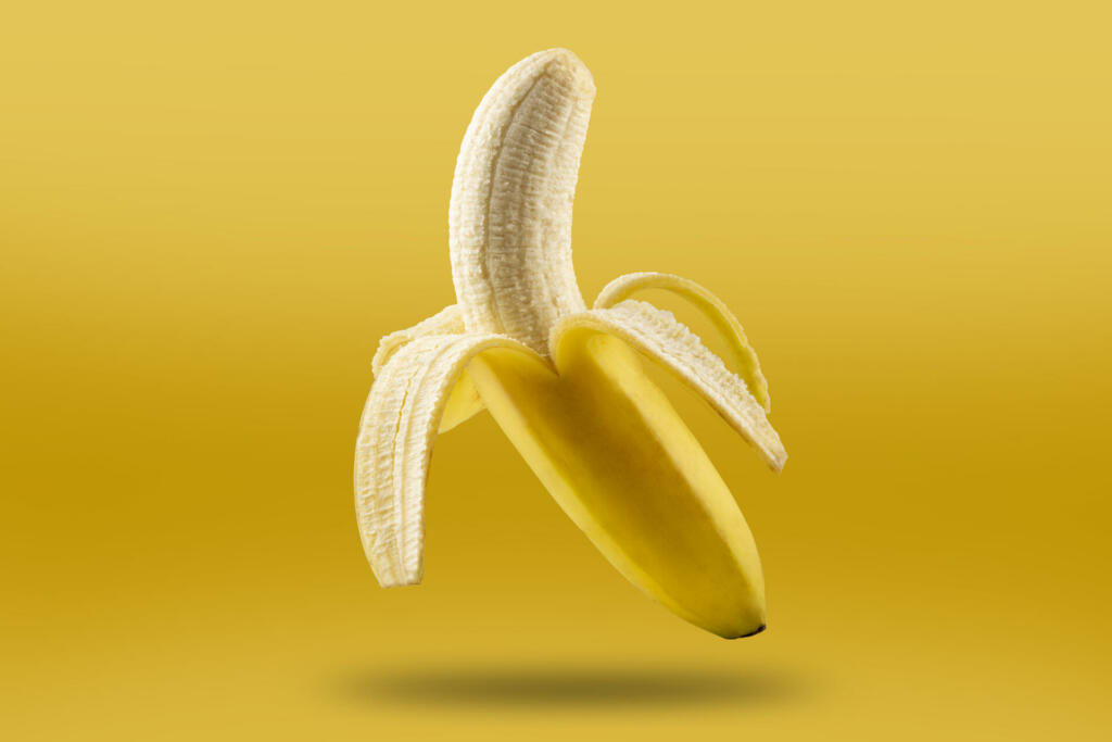 Ripe bananas isolated on yellow background.