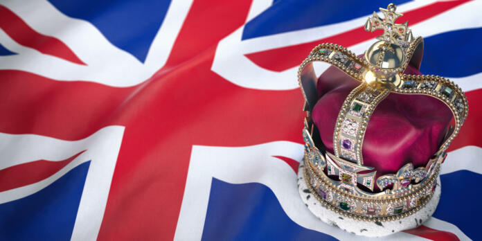 Royal golden crown with jewels on british  flag. Symbols of UK United Kingdom. 3d illustration