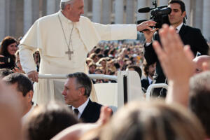 Vatican City State - October 30, 2013: Pope Francis I on the popemobile blesses the faithful crowd in St. Peter's Square in Vatican.